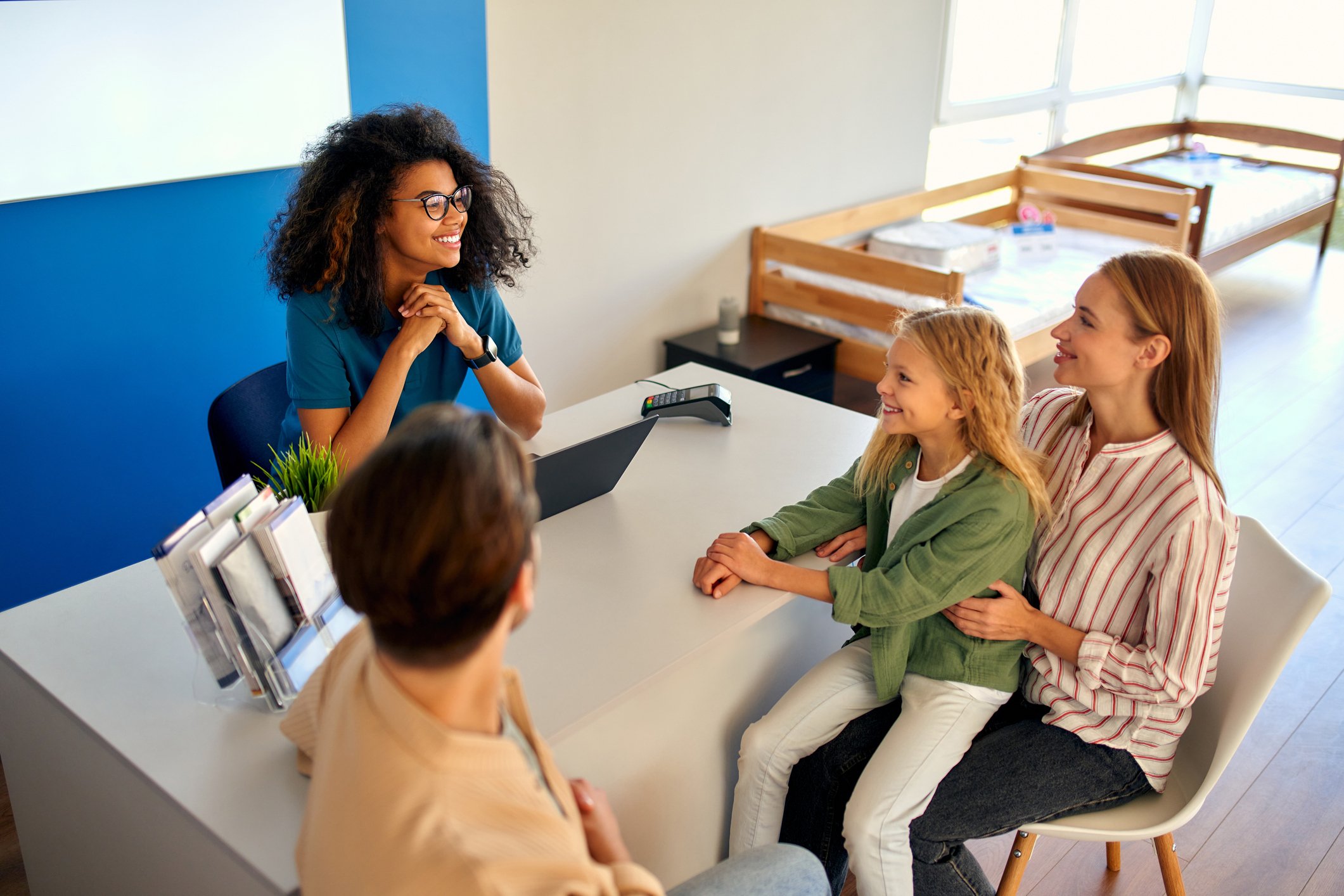 Caregiver interacting with children in a bright, welcoming space (2)