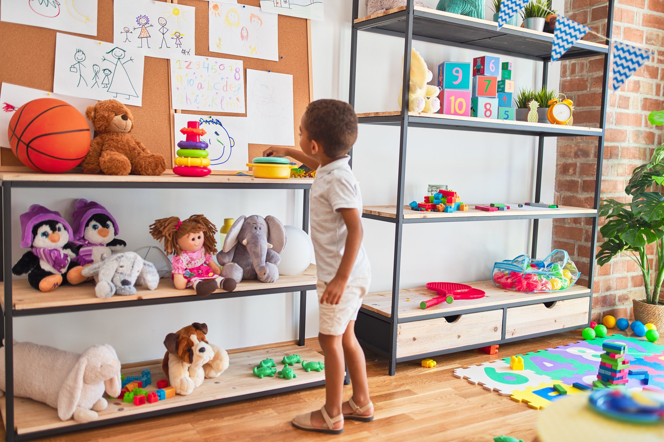 Child Exploring Montessori Classroom Shelves