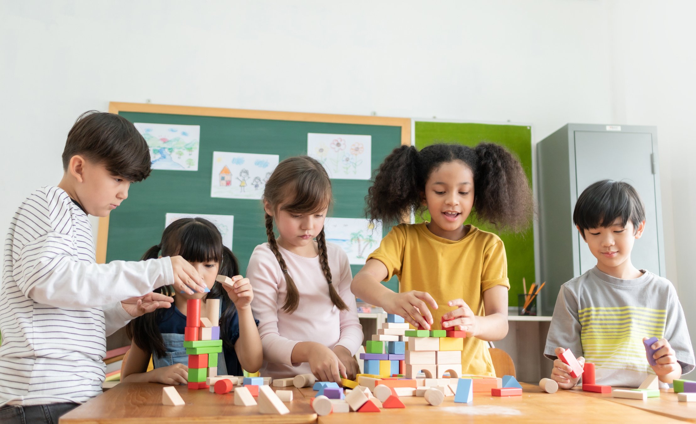 Children Building with Wooden Blocks in Montessori Class