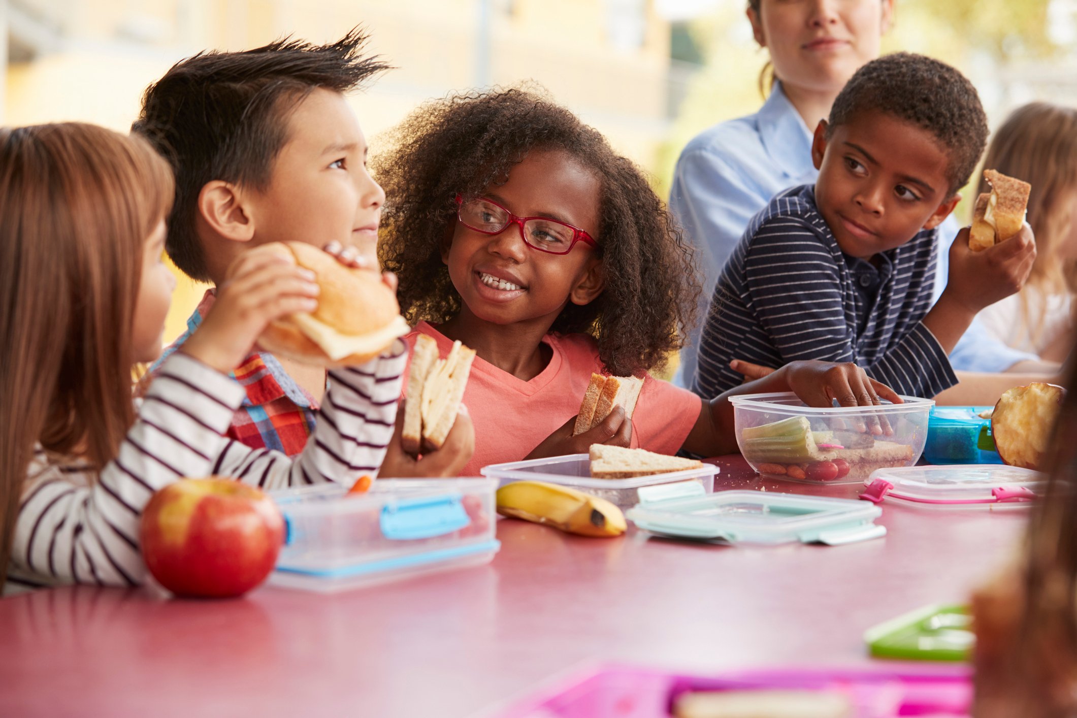 Group of diverse children enjoying breakfast together in a before school childcare program.
