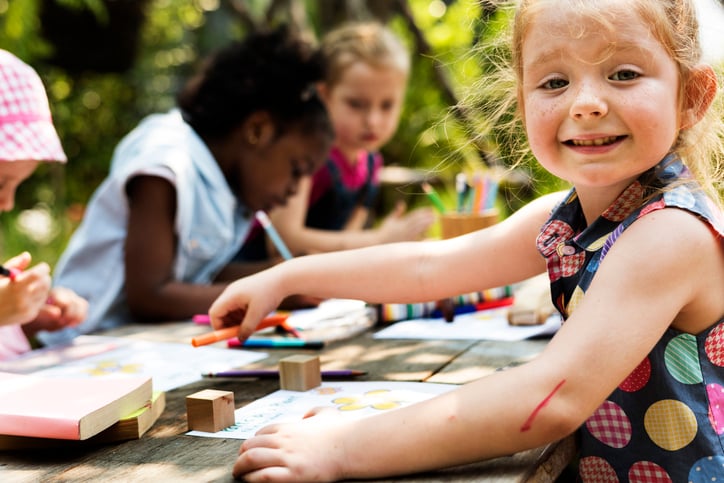 Girls group children drawing outdoors