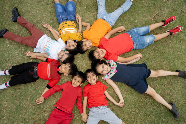 Happy young children laying in a circle