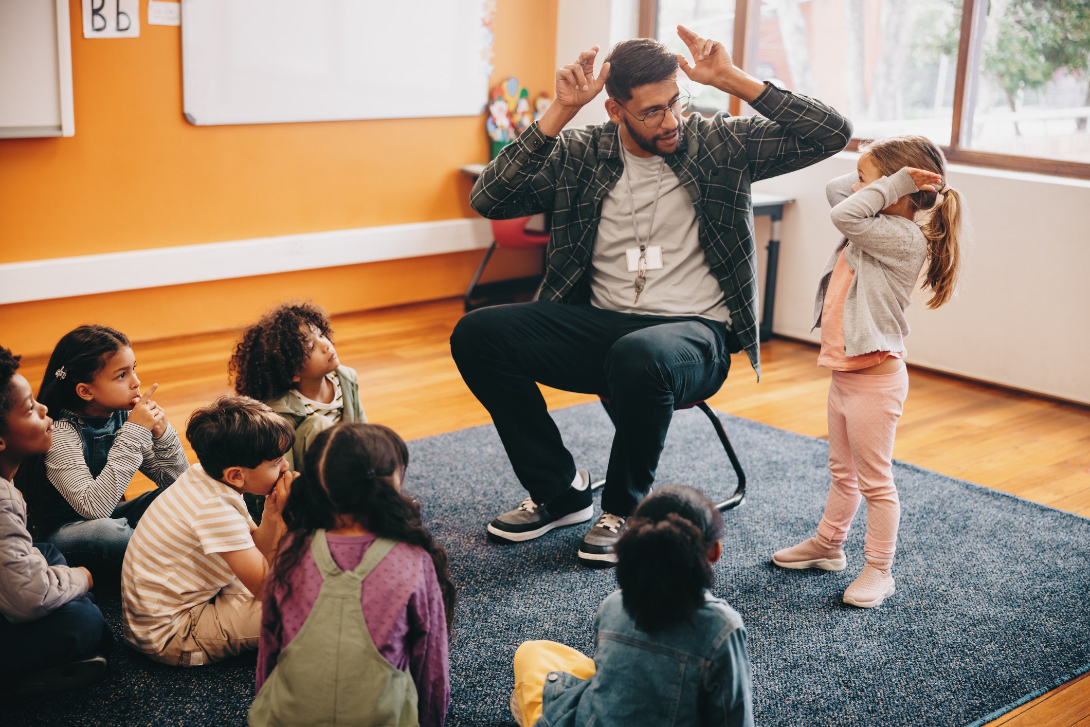Male educator in a primary school class.