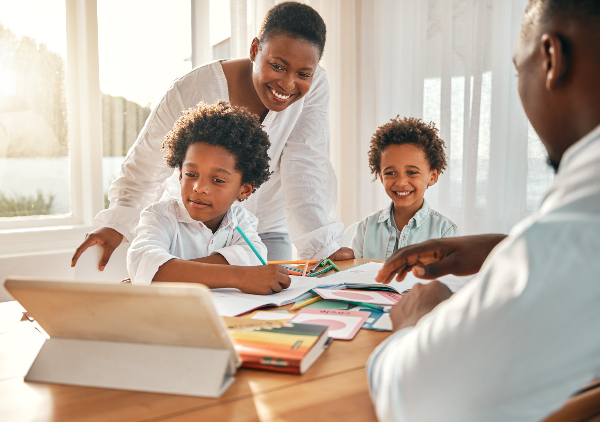 Parent and child comparing homeschool programs on laptop
