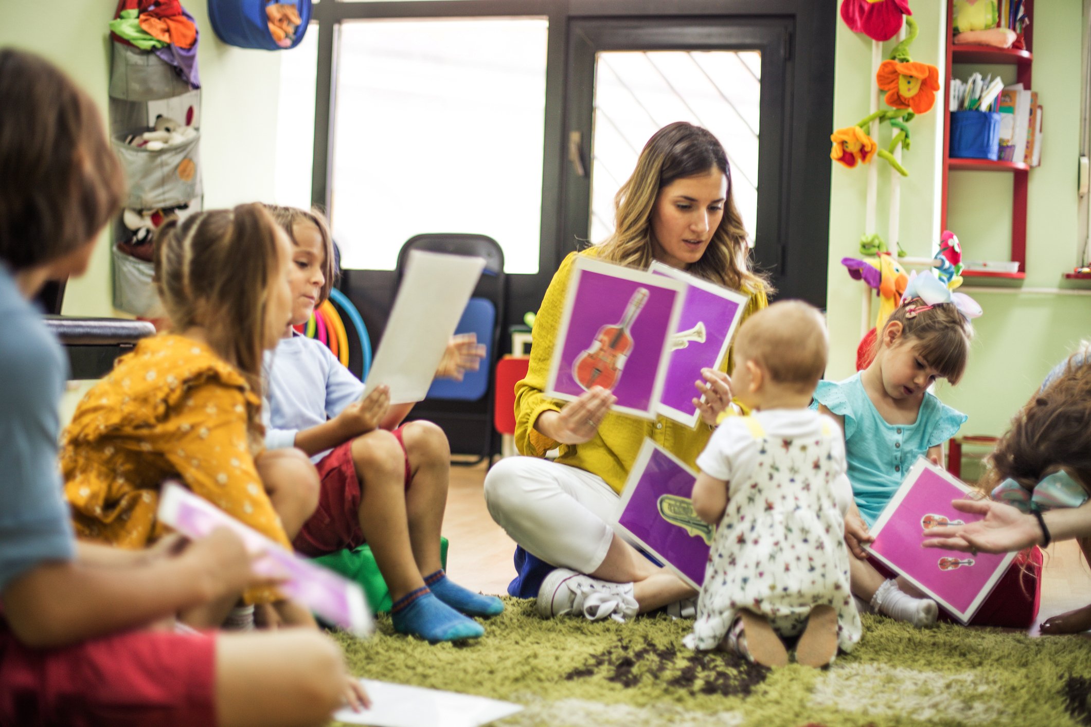 childcare provider with kids in a classroom