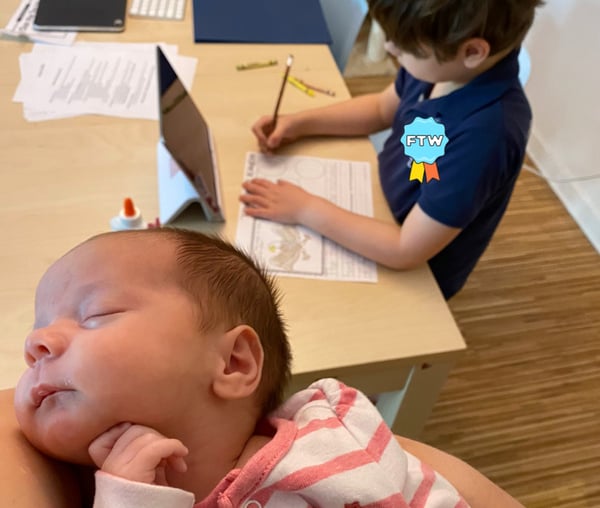 Holding a baby while homeschooling