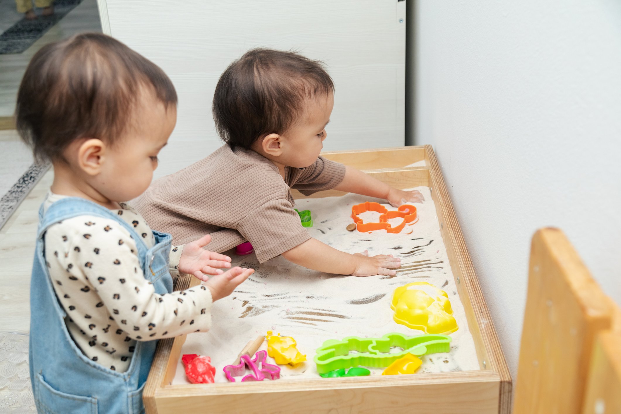 Toddlers playing in a sensory bin