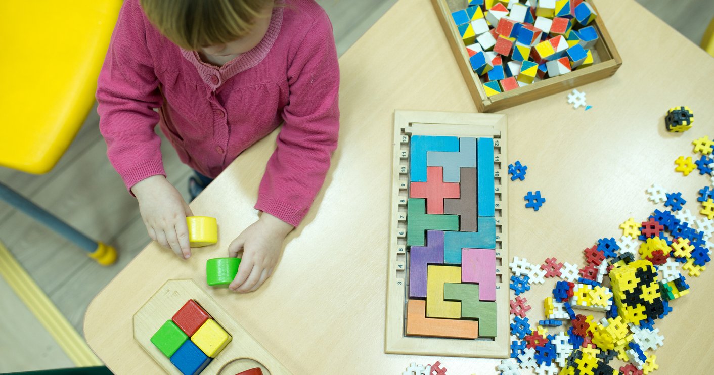 Preschooler using Montessori materials at home