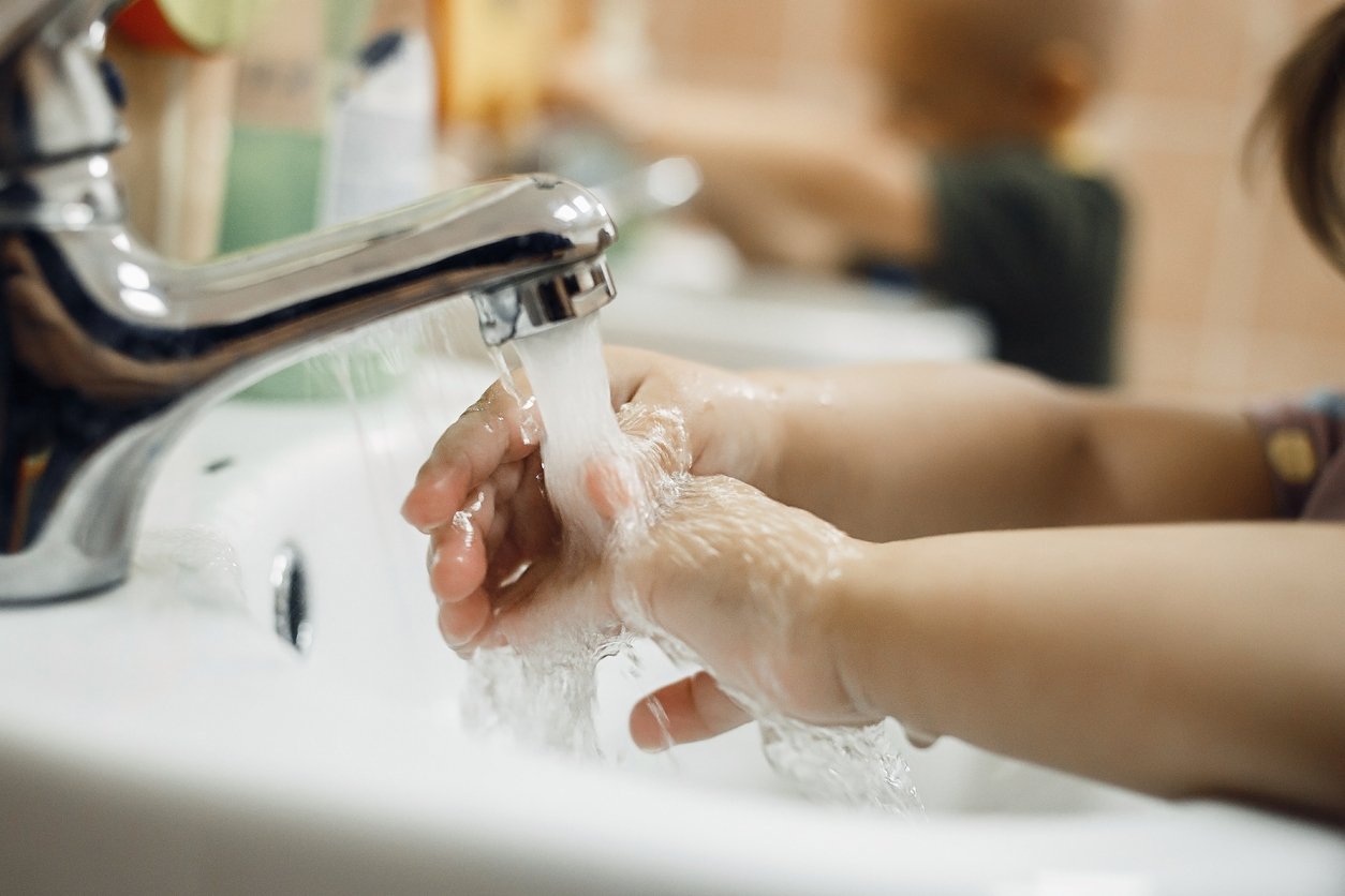 child washing his hands