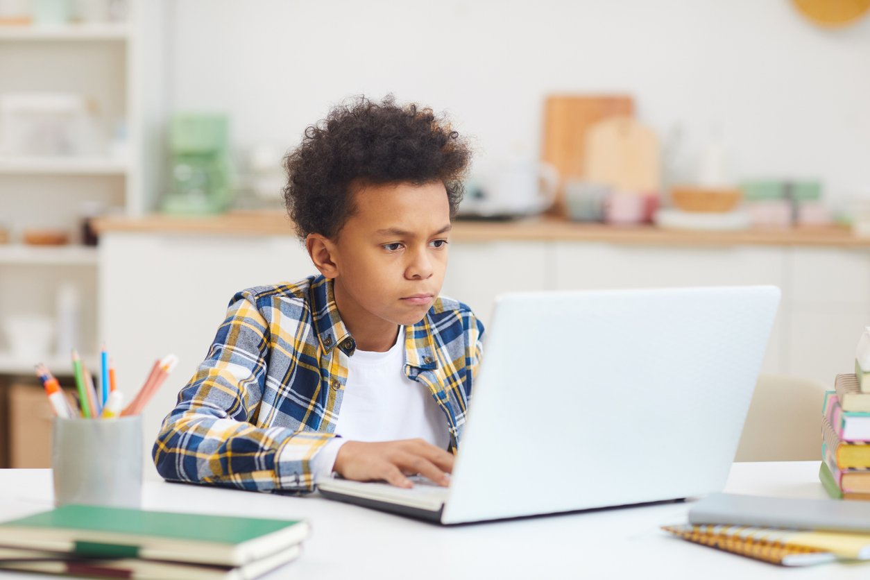 student learning from home via a computer