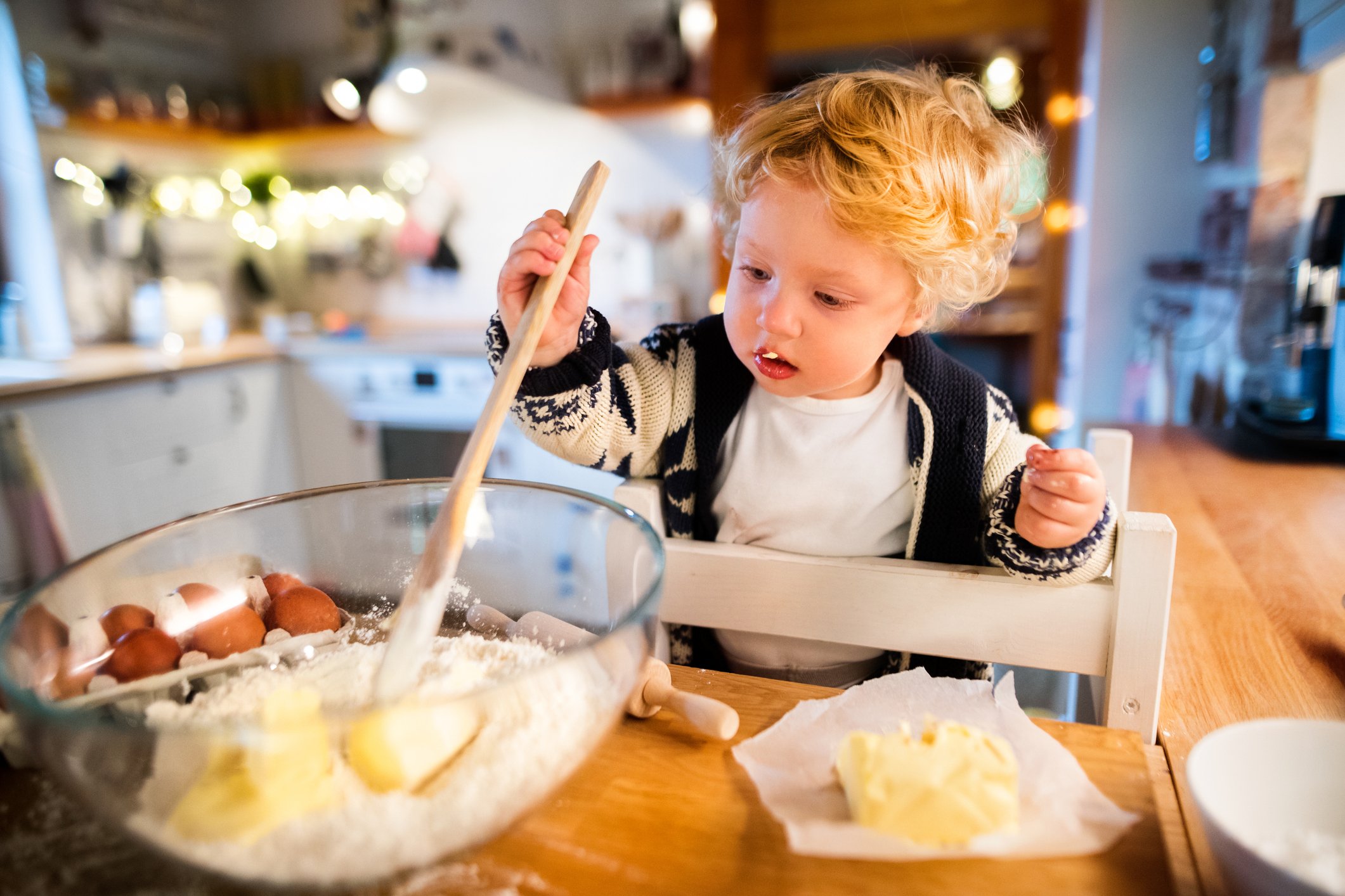 young child helping to cook