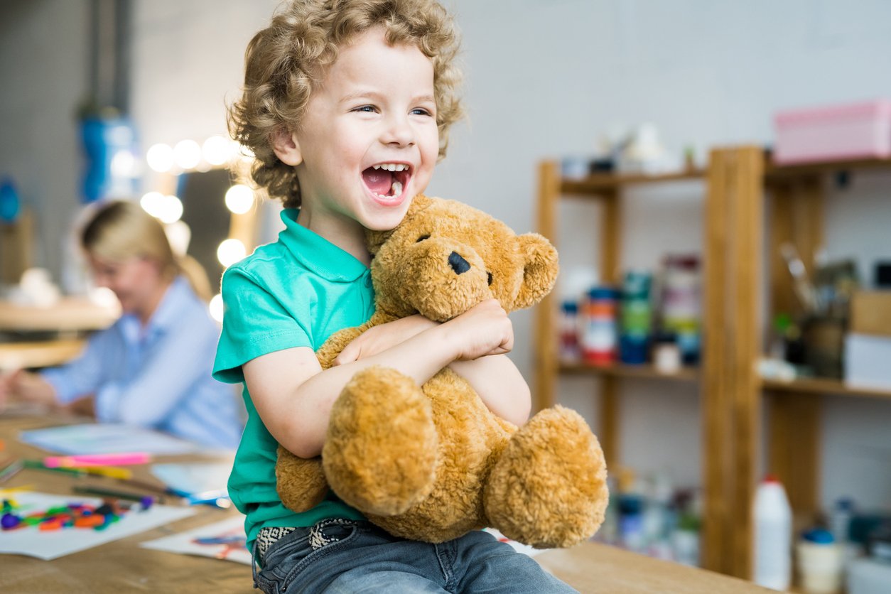 Young child holding teddy bear